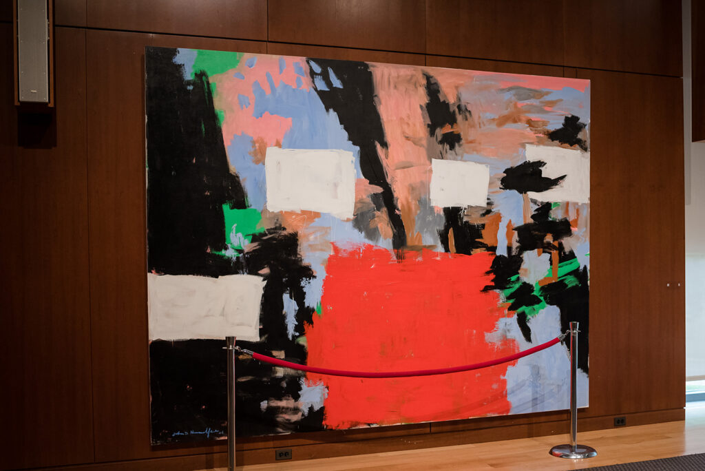 A colorful abstract painting by John Hultberg, titled 'Bridge Over the Stour', displayed at the New Britain Museum of American Art, adding an artistic touch to the wedding venue